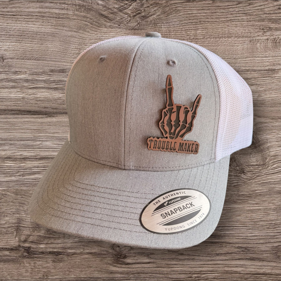 Trouble Maker Skeleton Hand Leather Patch Trucker Hat – Yupoong Snapback